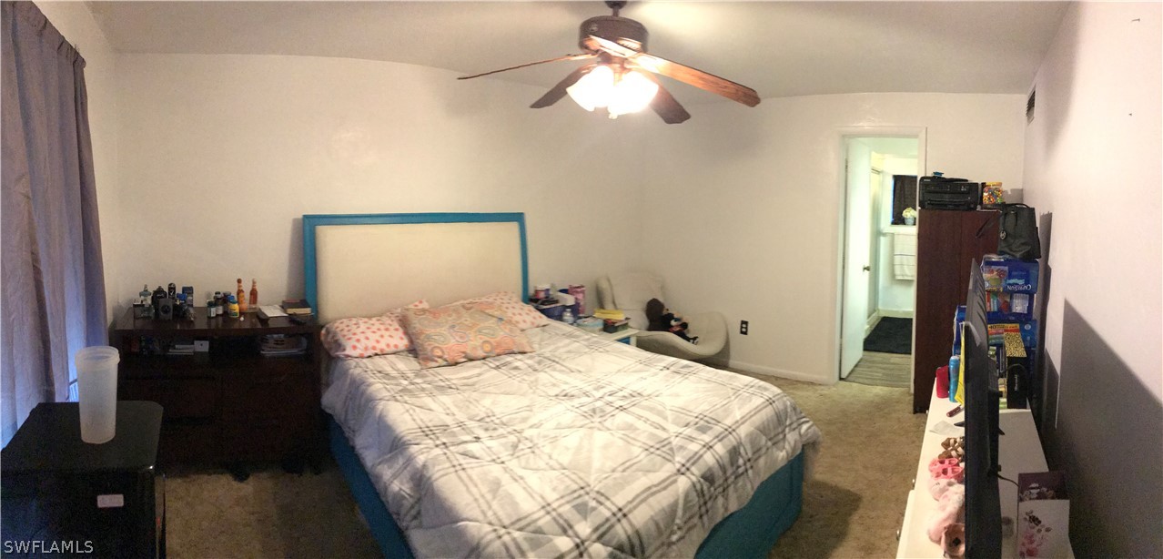 7312 Pebble Beach Road Fort Myers, FL 33967 - Photo 8 of 30 a bedroom with a bed dresser and a large mirror