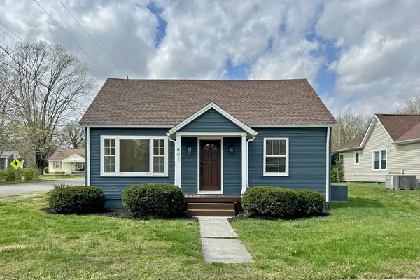 a view of a house with a yard and plants