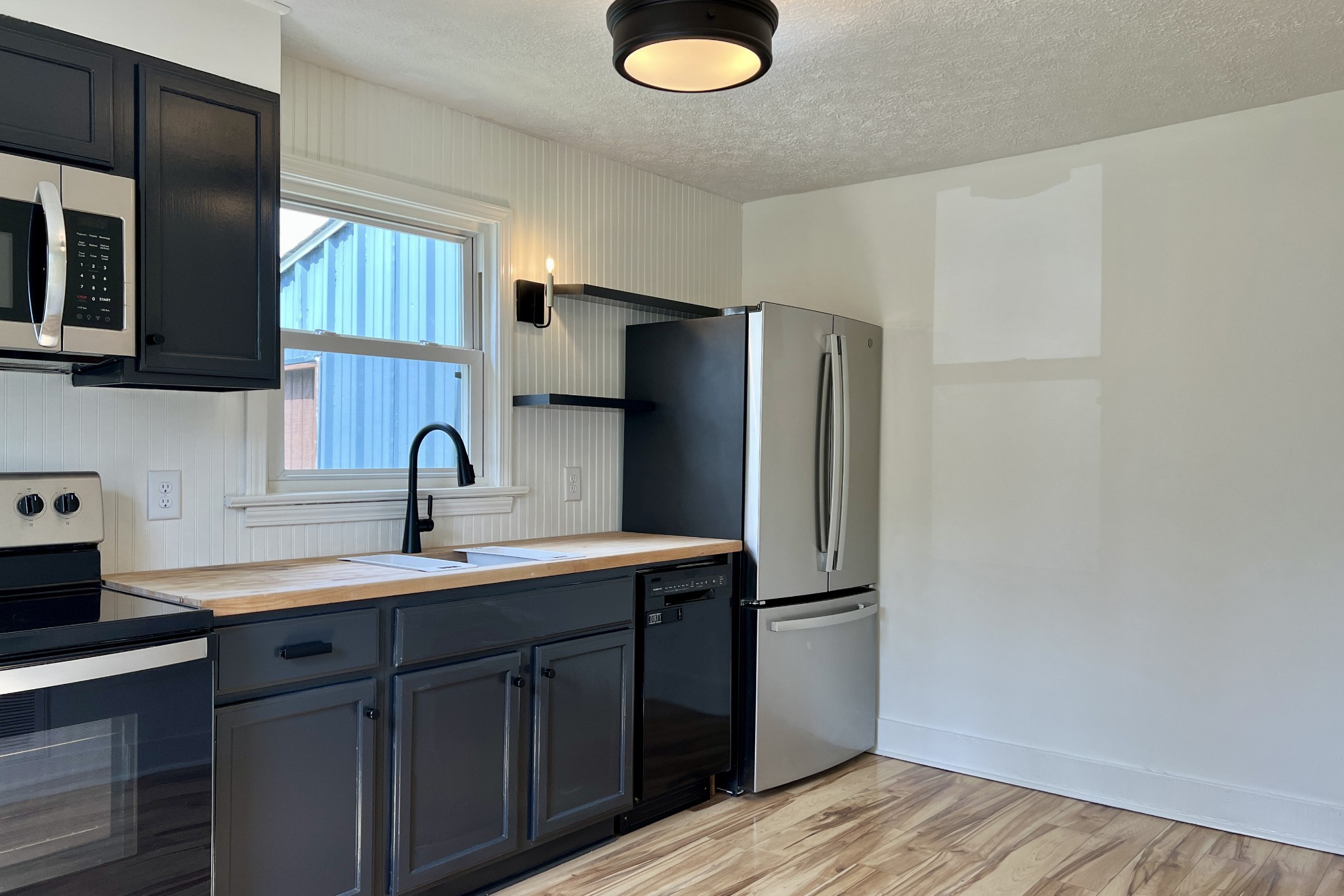 401 North High Street Franklin, KY 42134 - Photo 7 of 28 a kitchen with a sink a refrigerator and cabinets