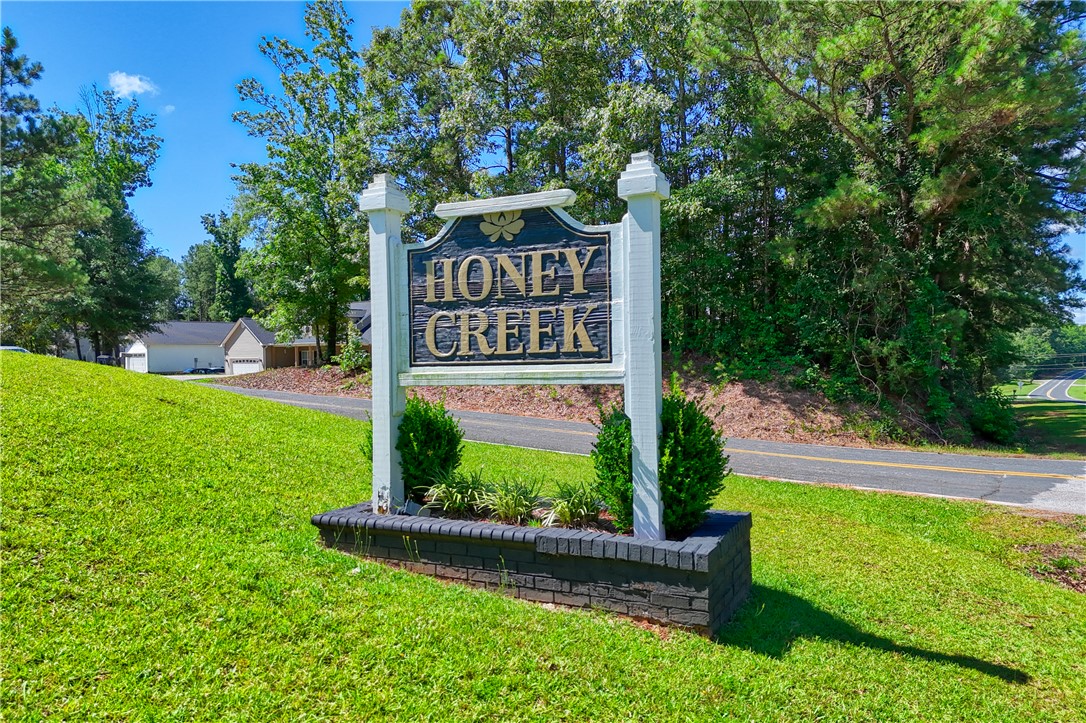 1020 Green Willow Trail Anderson, SC 29621 - Photo 22 of 28 An inviting sign marks the entrance to the Honey Creek community, nestled amongst lush greenery.