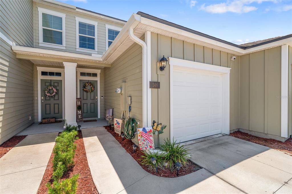 146 Redbud Road Palm Coast, FL 32137 - Photo 1 of 40 a front view of a house with a porch