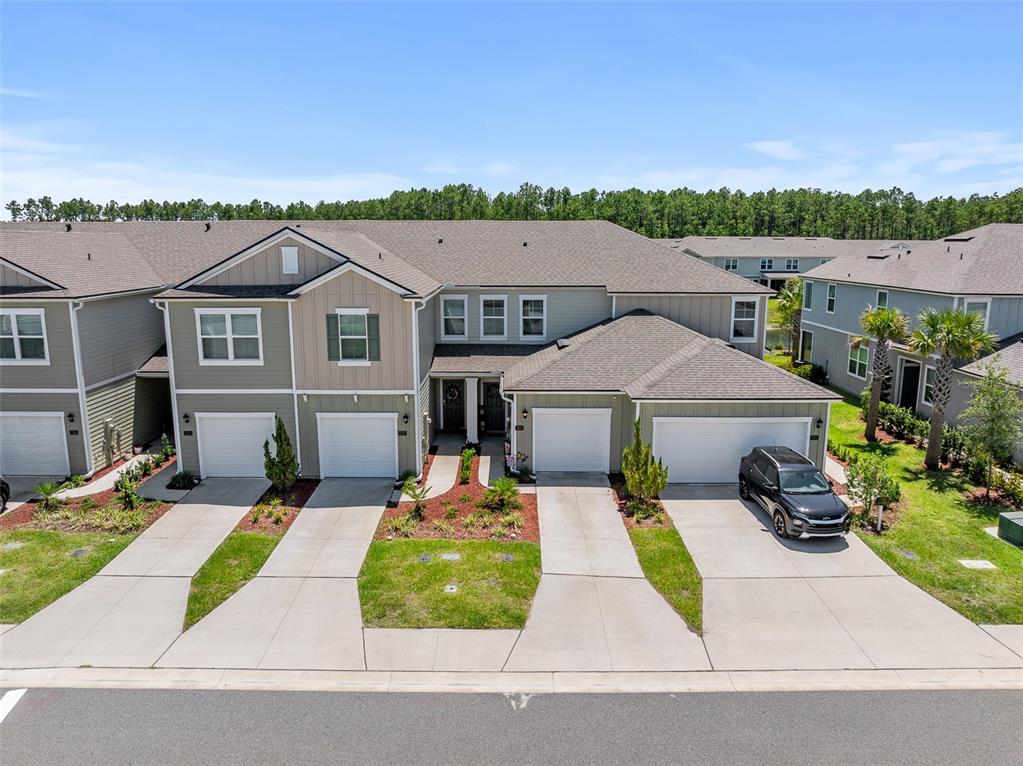 146 Redbud Road Palm Coast, FL 32137 - Photo 15 of 40 an aerial view of a house with yard patio and furniture