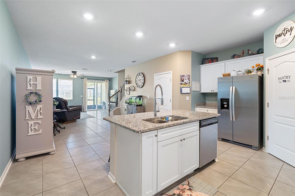 146 Redbud Road Palm Coast, FL 32137 - Photo 20 of 40 a kitchen with stainless steel appliances granite countertop a refrigerator and a stove