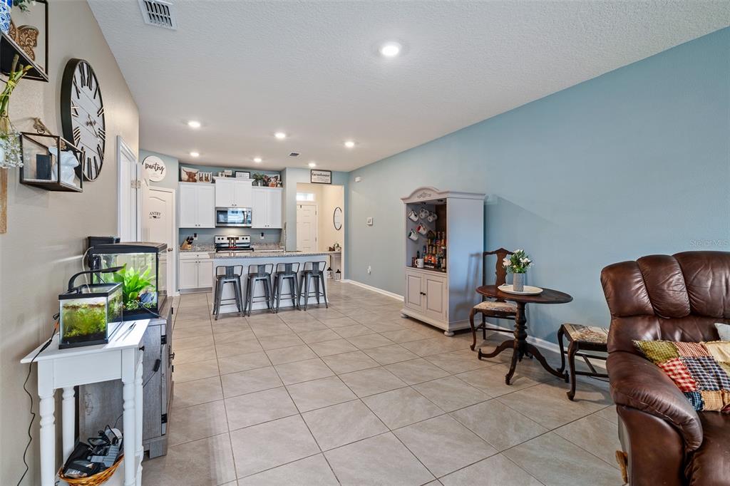 146 Redbud Road Palm Coast, FL 32137 - Photo 21 of 40 a kitchen with stainless steel appliances kitchen island granite top and refrigerator