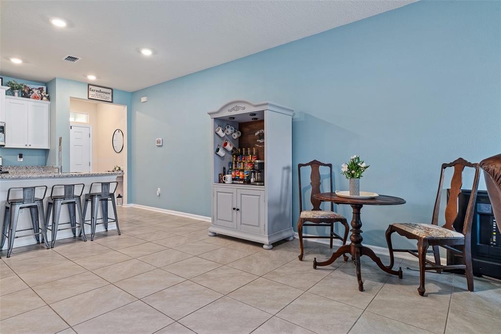 146 Redbud Road Palm Coast, FL 32137 - Photo 22 of 40 a living room with furniture and a dining table