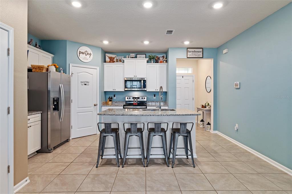 146 Redbud Road Palm Coast, FL 32137 - Photo 23 of 40 a kitchen with stainless steel appliances a refrigerator and microwave