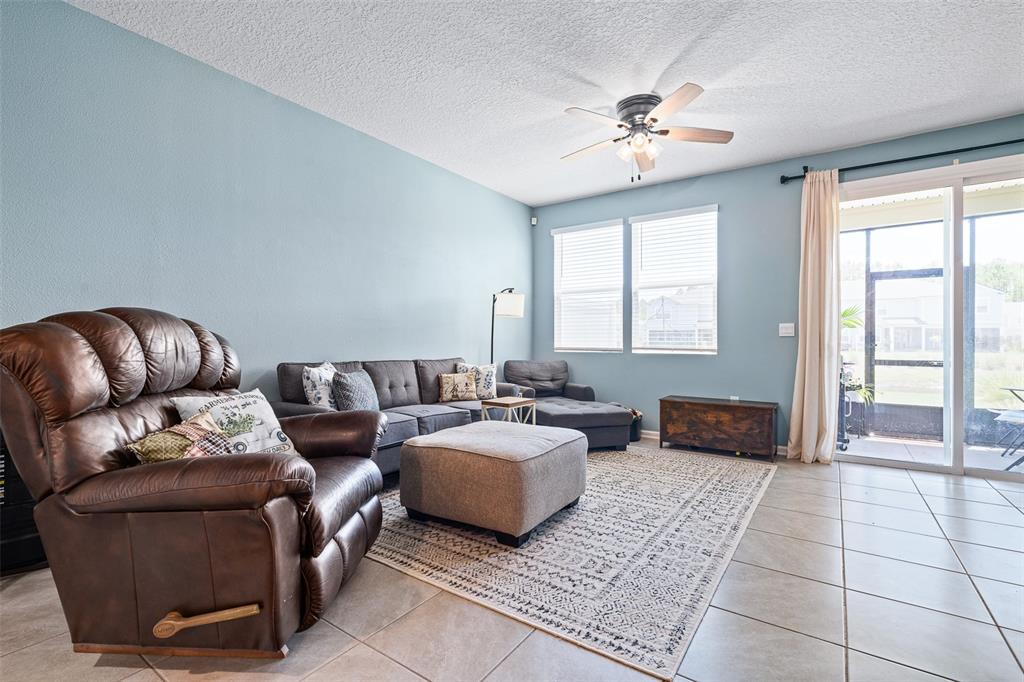 146 Redbud Road Palm Coast, FL 32137 - Photo 25 of 40 a living room with furniture and a chandelier