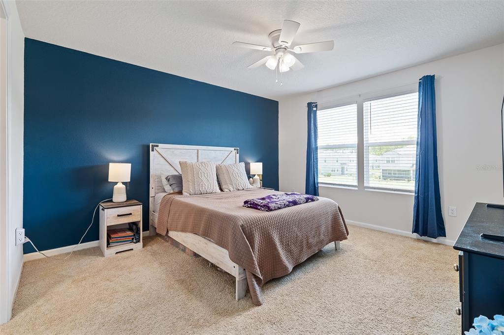 146 Redbud Road Palm Coast, FL 32137 - Photo 31 of 40 a bedroom with a bed chair and a window