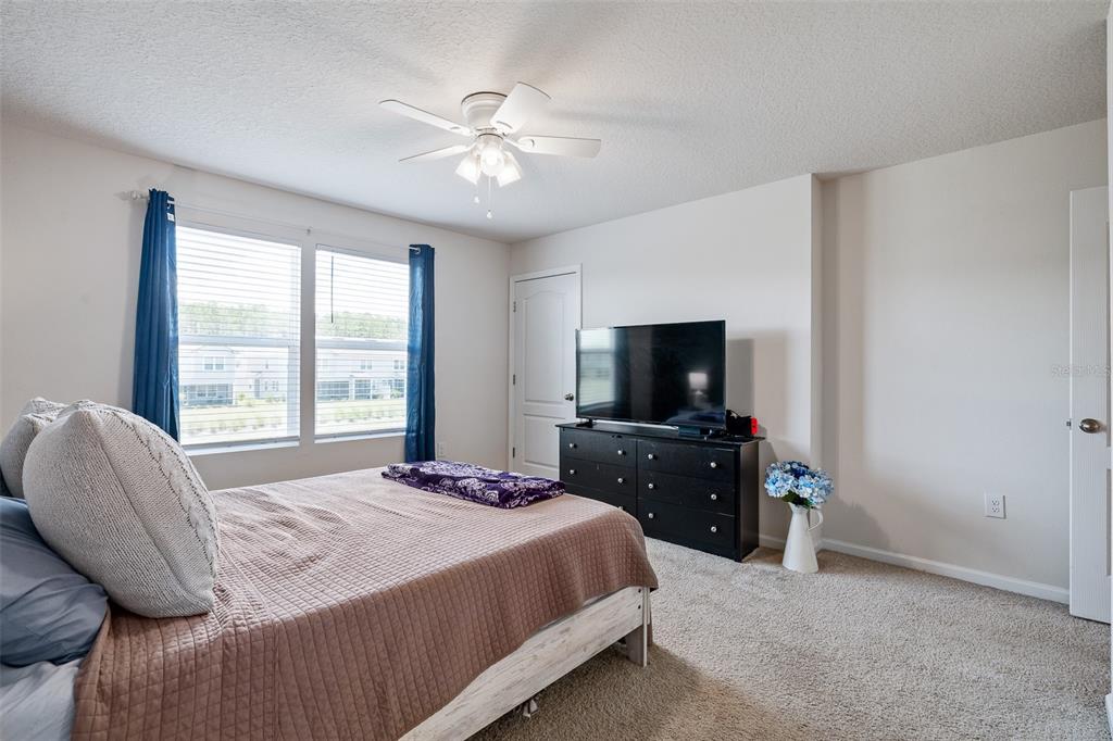 146 Redbud Road Palm Coast, FL 32137 - Photo 33 of 40 a bedroom with a bed and a flat screen tv