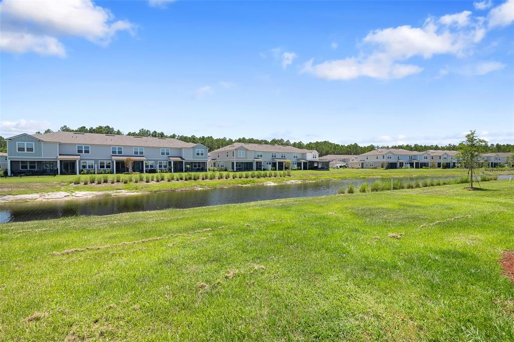 146 Redbud Road Palm Coast, FL 32137 - Photo 36 of 40 a view of a city with lawn chairs and large trees