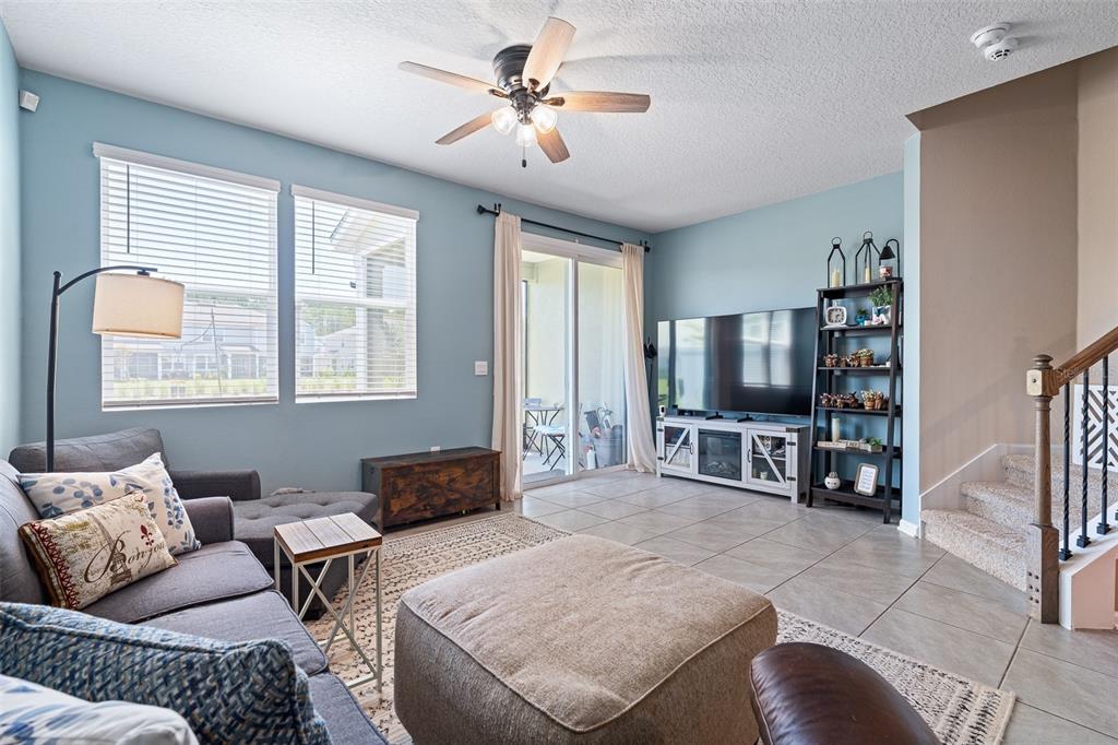 146 Redbud Road Palm Coast, FL 32137 - Photo 5 of 40 a living room with furniture a large window and a flat screen tv