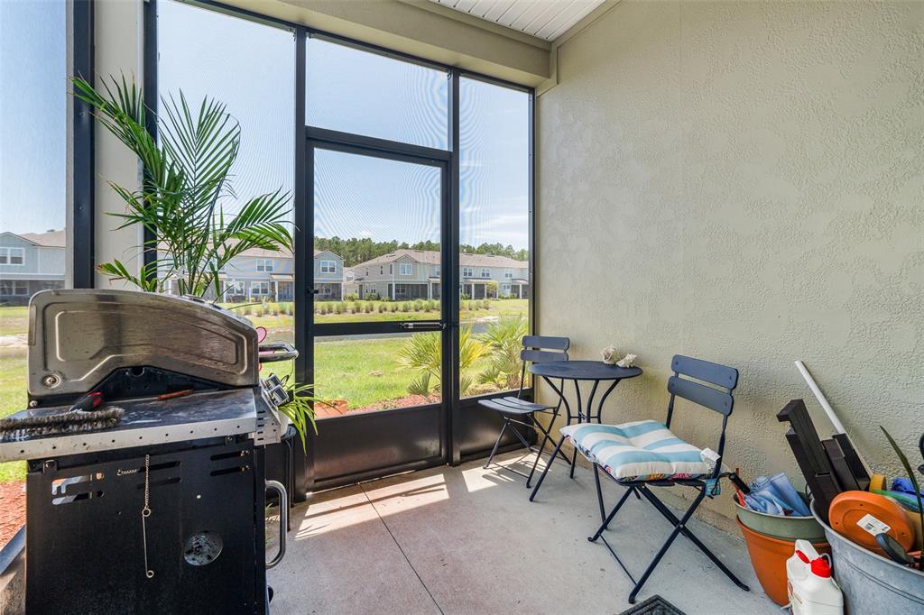 146 Redbud Road Palm Coast, FL 32137 - Photo 6 of 40 a living room with furniture and a floor to ceiling window