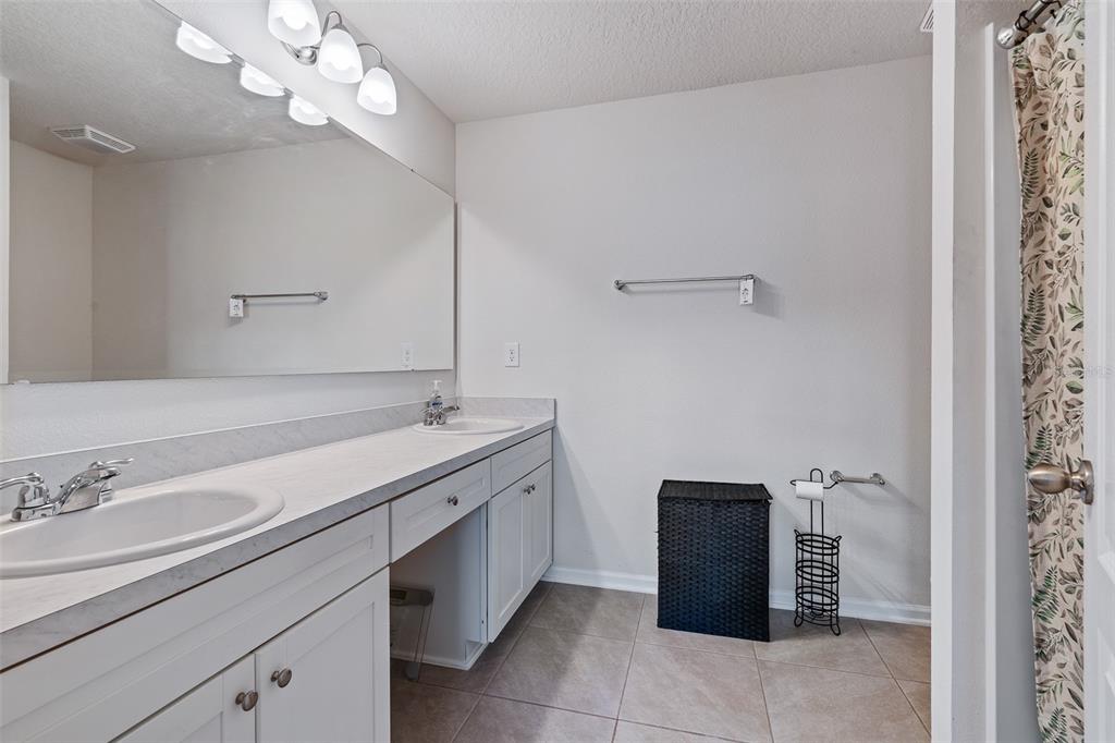146 Redbud Road Palm Coast, FL 32137 - Photo 8 of 40 a bathroom with a sink a vanity and a mirror