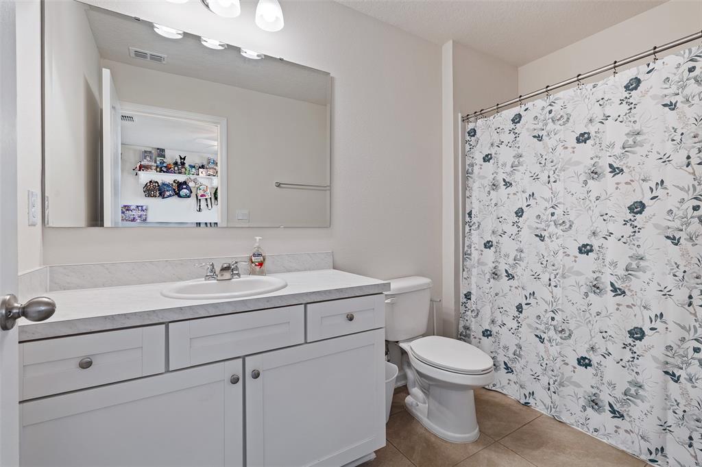 146 Redbud Road Palm Coast, FL 32137 - Photo 10 of 40 a bathroom with a toilet sink and mirror