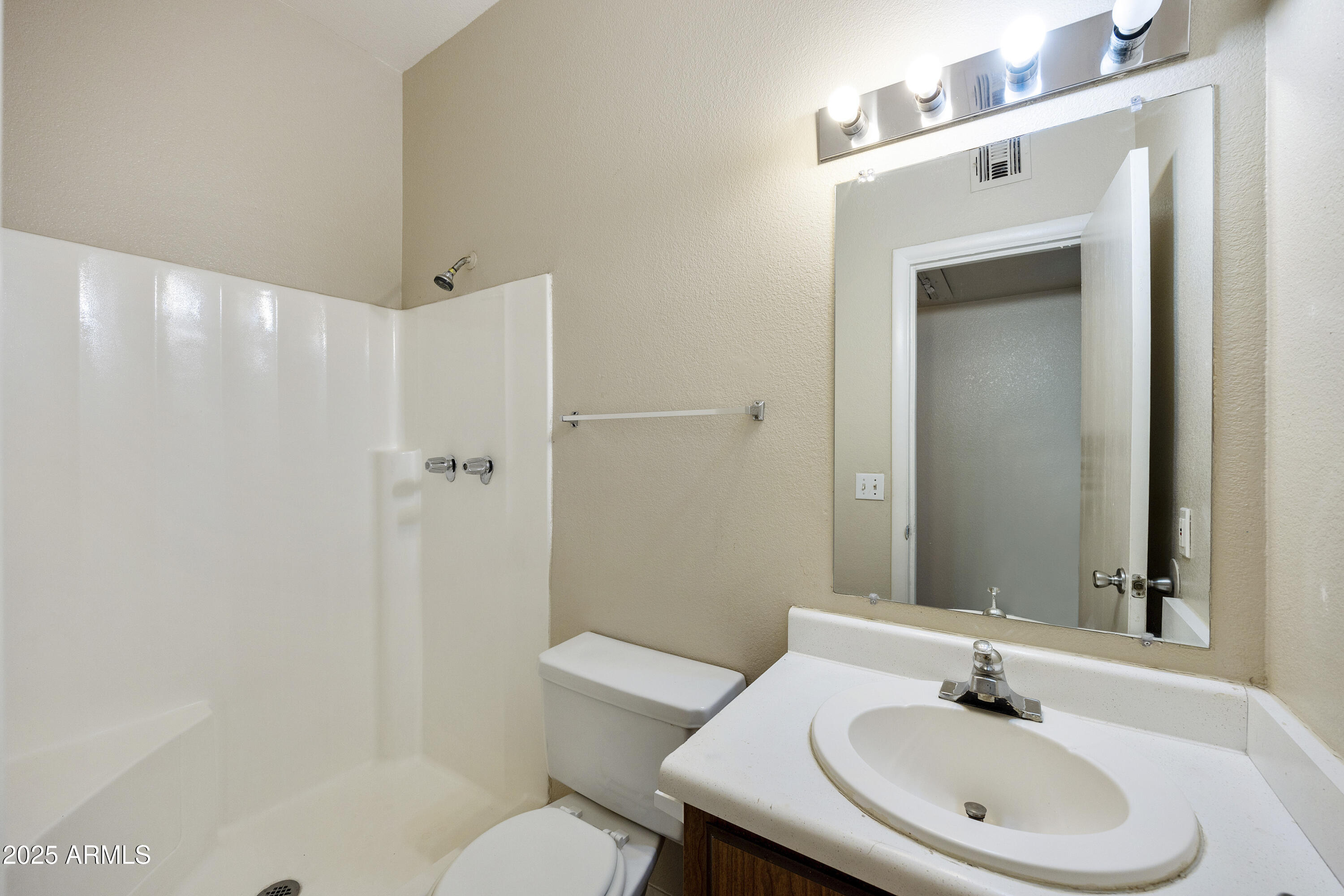 2837 East Marconi Avenue, Unit 102 Phoenix, AZ 85032 - Photo 3 of 8 a bathroom with a sink a toilet and shower