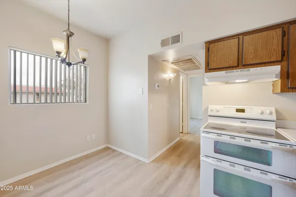 a kitchen with a stove cabinets and wooden floor