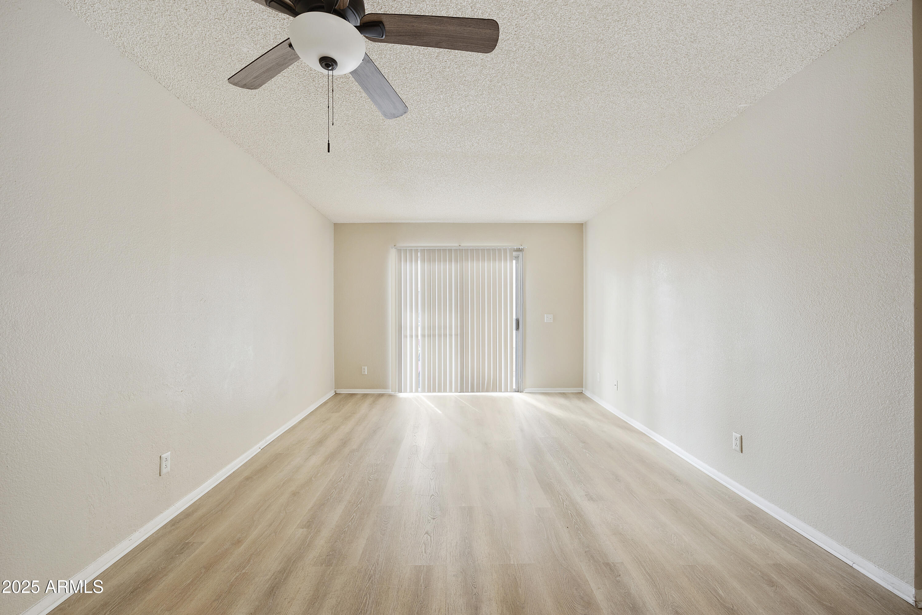 2837 East Marconi Avenue, Unit 102 Phoenix, AZ 85032 - Photo 7 of 8 a view of an empty room with a chandelier fan