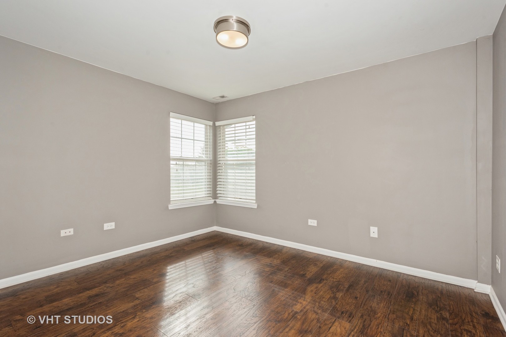 644 Lancaster Circle Elgin, IL 60123 - Photo 11 of 21 an empty room with wooden floor and windows