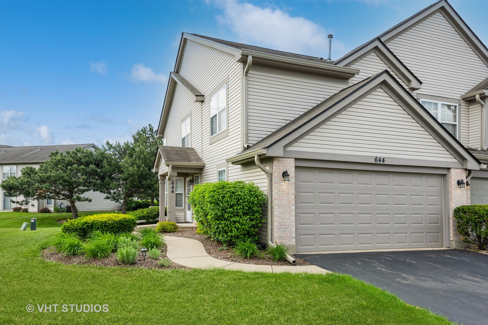 644 Lancaster Circle Elgin, IL 60123 - Photo 2 of 21 a view of a white house next to a yard