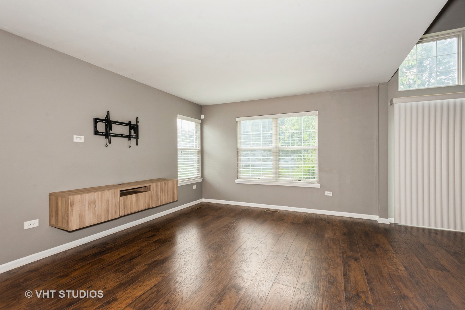 644 Lancaster Circle Elgin, IL 60123 - Photo 4 of 21 an empty room with wooden floor and windows