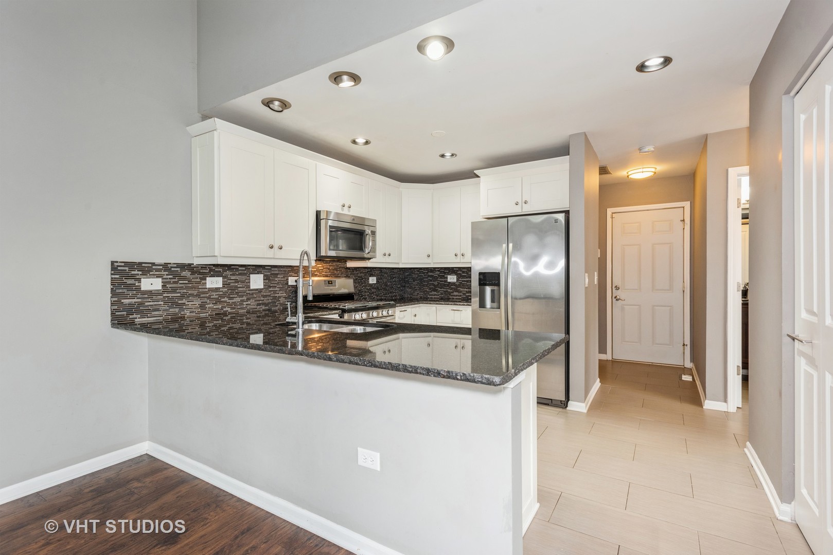 644 Lancaster Circle Elgin, IL 60123 - Photo 7 of 21 a kitchen with stainless steel appliances granite countertop a refrigerator and a sink