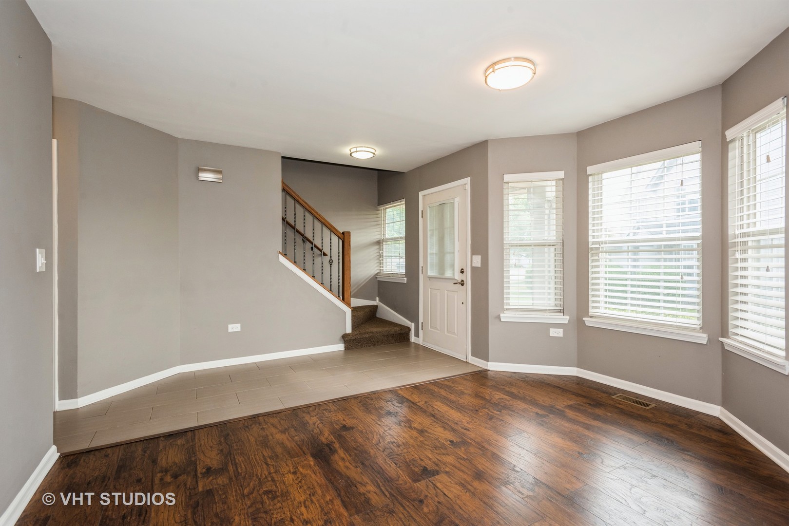 644 Lancaster Circle Elgin, IL 60123 - Photo 10 of 21 a view of an empty room with wooden floor and a window