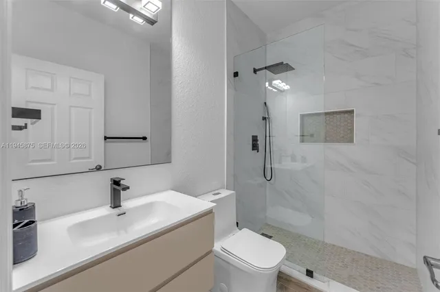 a bathroom with a sink toilet and shower