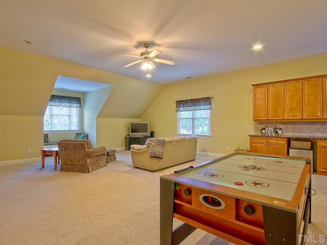 1812 Stannard Trail Raleigh, NC 27612 - Photo 15 of 25 The expansive bonus is so large that the room can be divided into multi-purpose areas. Features include a wet bar with ample storage and a ceiling fan. To the right of the cabinets you will find the access for the back stairs. Bonus Room