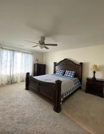 a bedroom with a bed and a window