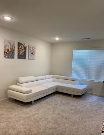 a bedroom with furniture and a flat screen tv