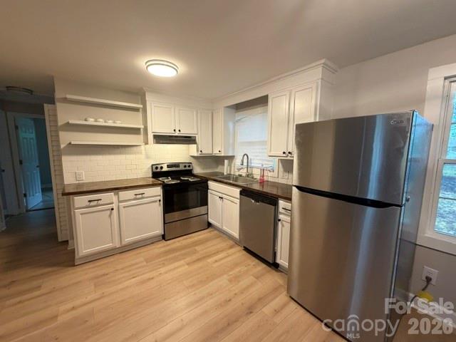 1450 3rd Street Southwest Hickory, NC 28602 - Photo 5 of 17 a kitchen with a refrigerator a stove top oven and cabinets