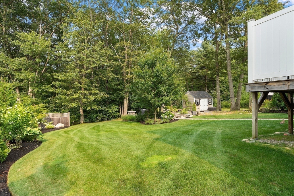 46 Jordan Road Holden, MA 01520 - Photo 34 of 42 a view of a backyard with table and chairs and potted plants and large trees