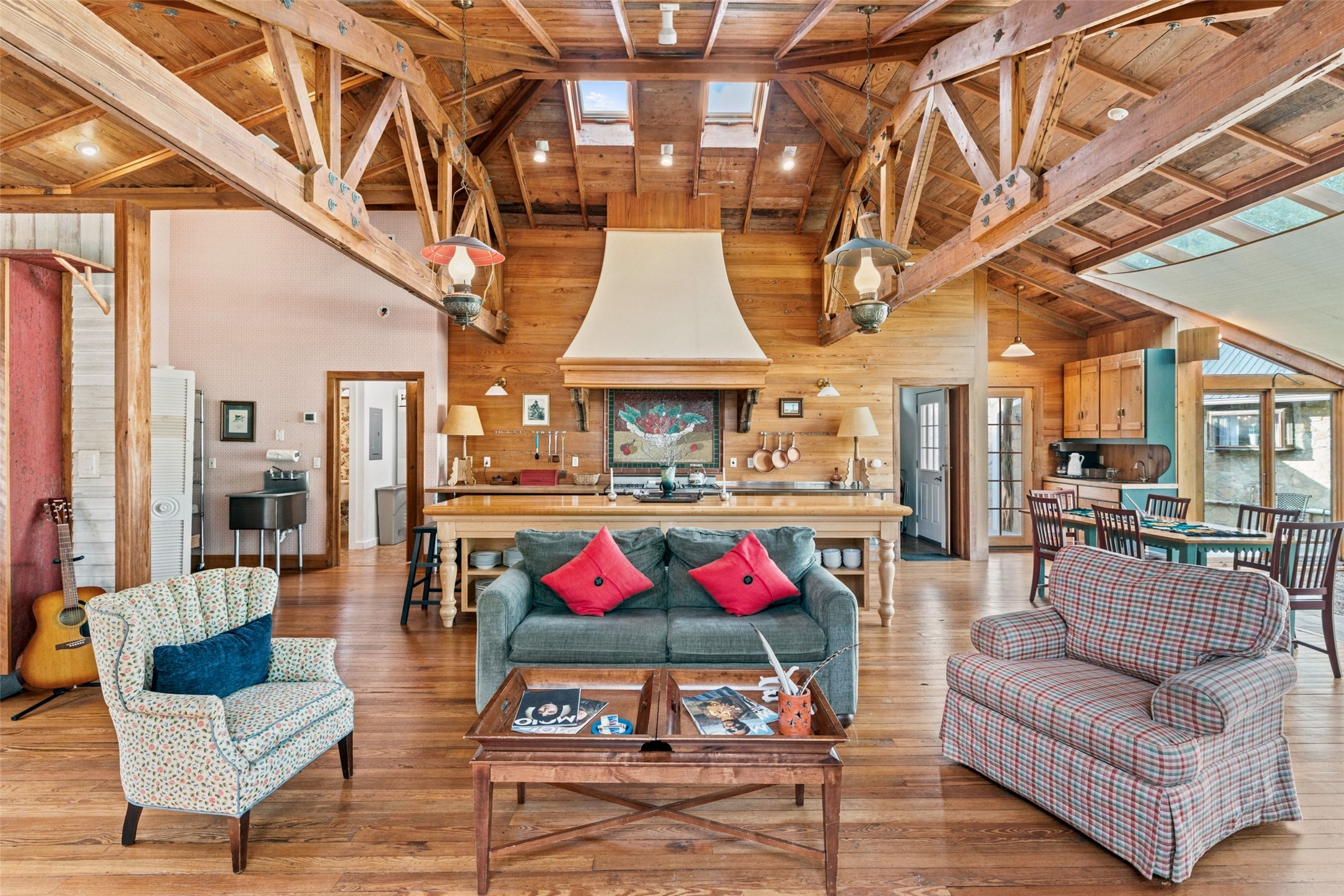 505 Red Corral Ranch Road Wimberley, TX 78676 - Photo 22 of 40 Natural wood ceilings with exposed beams define this spacious, open-concept living area with a central kitchen island.