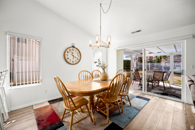 1825 West Mathis Park Place, Unit 46 St. George, UT 84770 - Photo 17 of 45 Dining space with light wood-type flooring, hanging lights, and vaulted ceiling