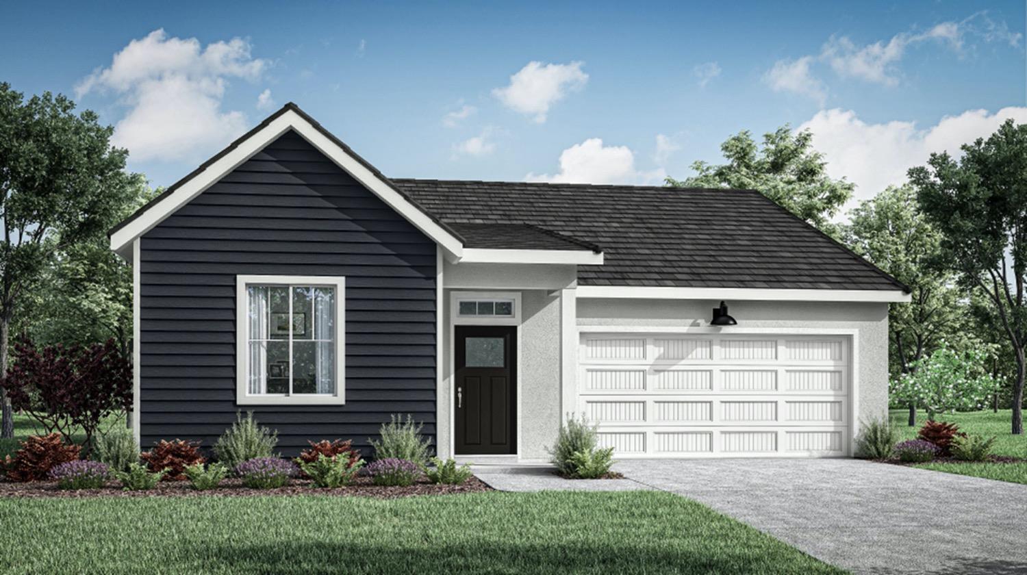 a front view of a house with a garden and plants