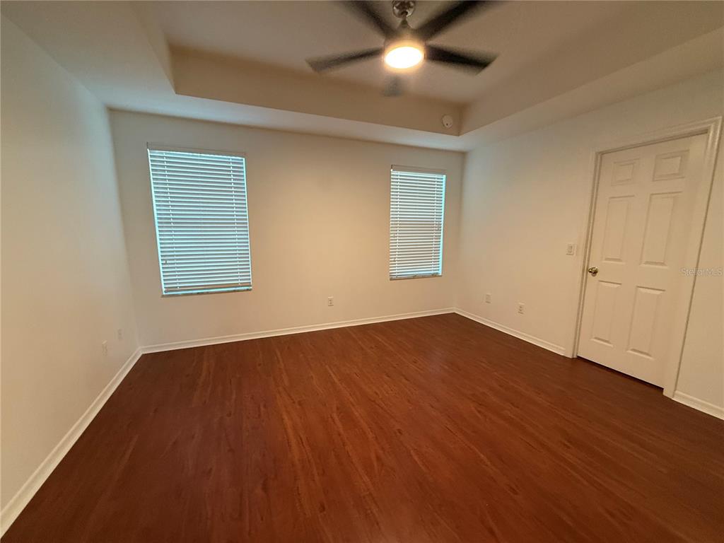 2624 Sweet Magnolia Place Oviedo, FL 32765 - Photo 18 of 25 an empty room with wooden floor and windows