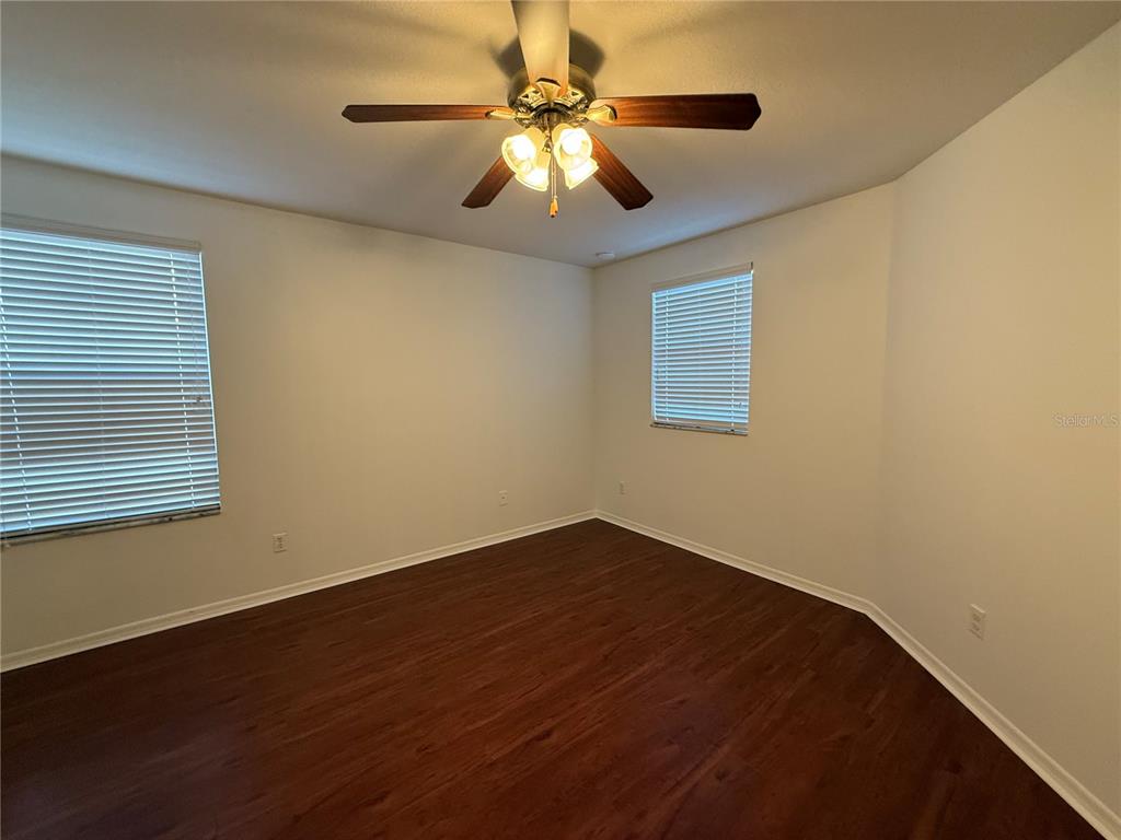 2624 Sweet Magnolia Place Oviedo, FL 32765 - Photo 20 of 25 an empty room with wooden floor and windows