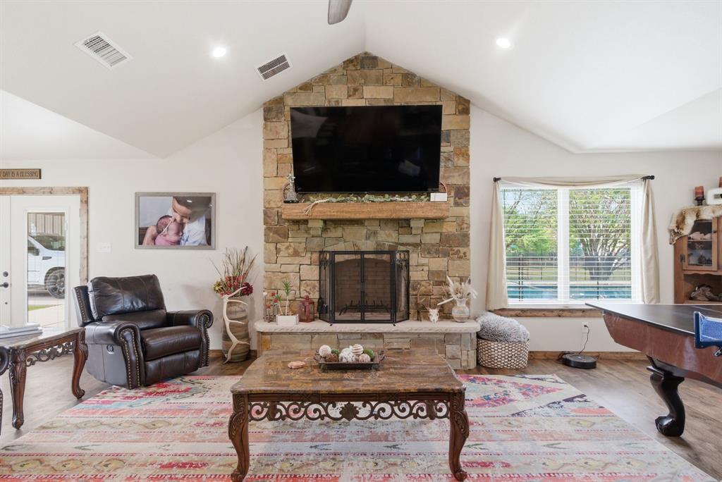 187 County Road 4195 Decatur, TX 76234 - Photo 8 of 40 a living room with furniture a flat screen tv and a fireplace