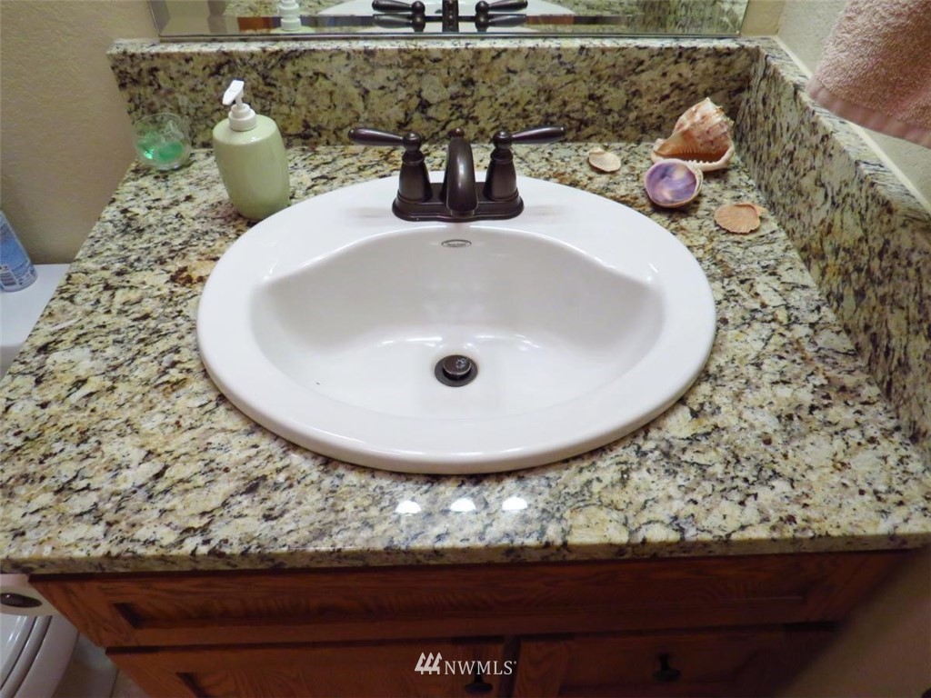 440 West Silberhorn Road Sequim, WA 98382 - Photo 22 of 40 a bathroom with a granite countertop sink and a mirror