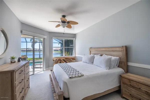 a bedroom with a large bed and a chandelier
