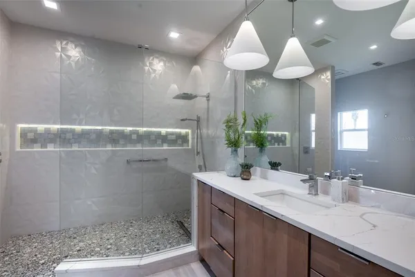 a kitchen with stainless steel appliances granite countertop sink stove top oven and refrigerator