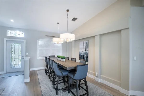 a view of a dining room with furniture window and wooden floor