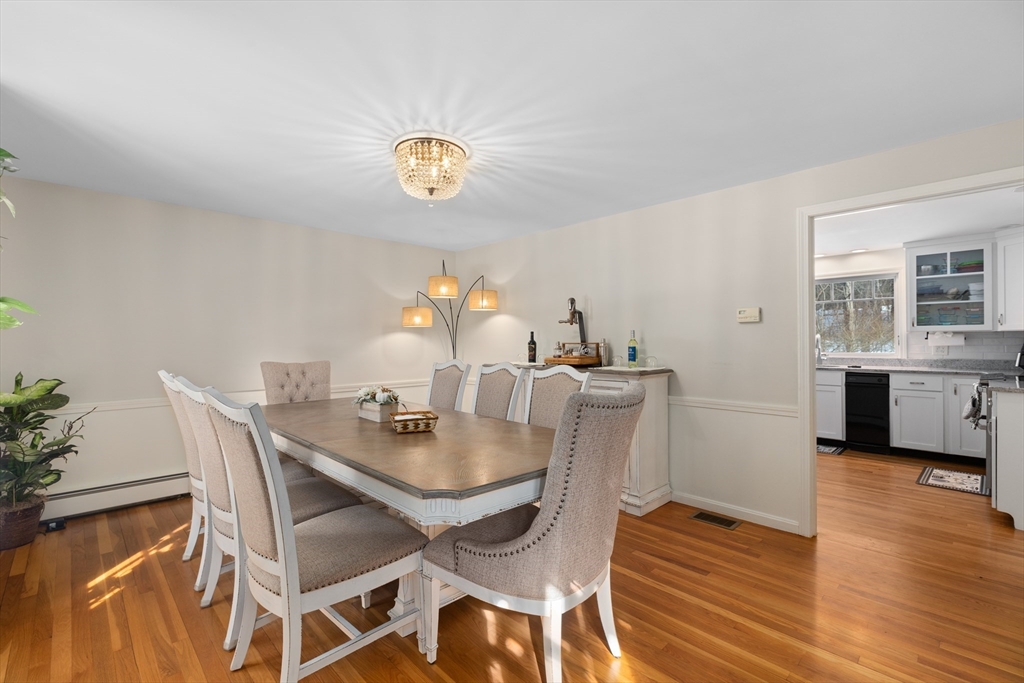 180 Rowley Bridge Road Topsfield, MA 01983 - Photo 15 of 42 a view of a dining room with furniture and wooden floor