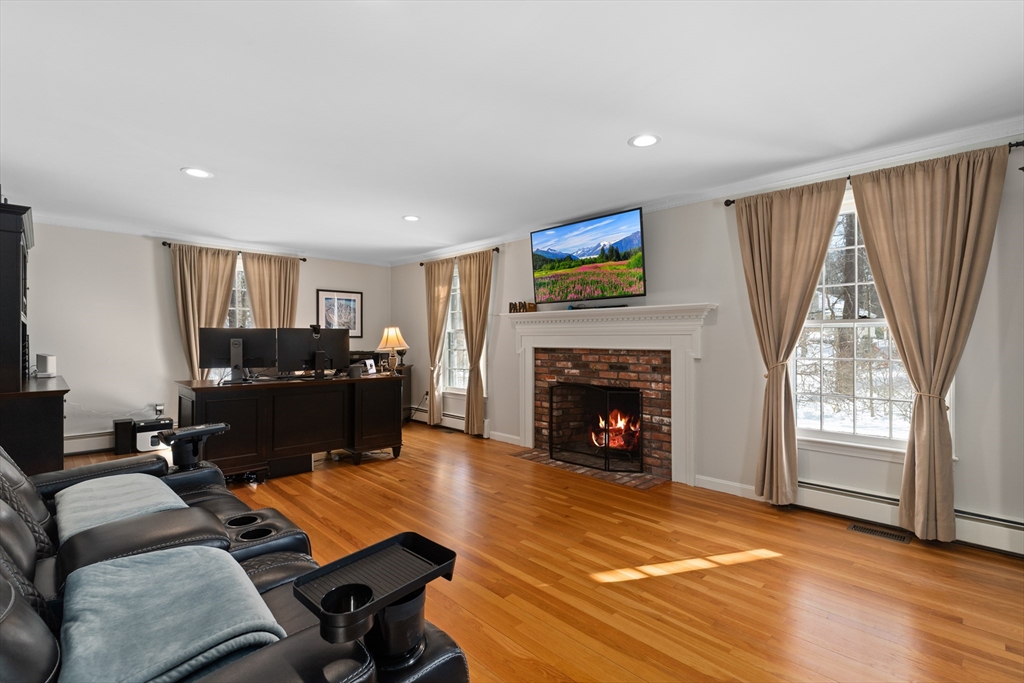 180 Rowley Bridge Road Topsfield, MA 01983 - Photo 17 of 42 a living room with furniture a fireplace and a large window