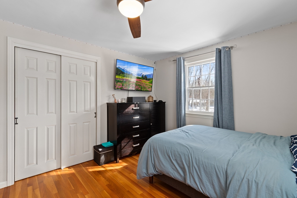180 Rowley Bridge Road Topsfield, MA 01983 - Photo 22 of 42 a bedroom with a bed and a flat tv screen on dresser
