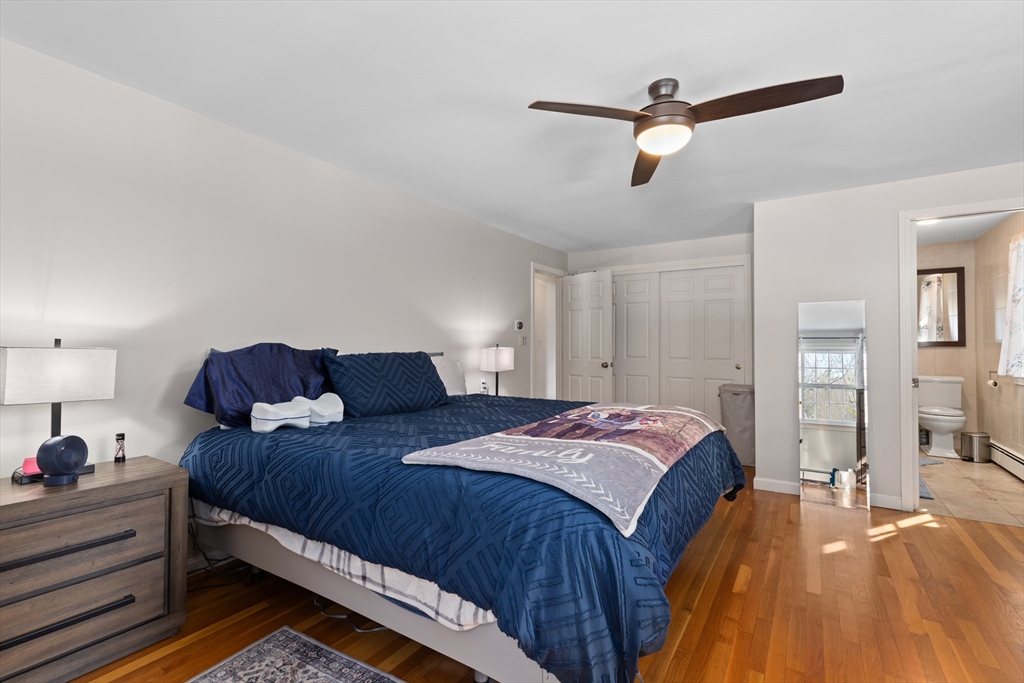 180 Rowley Bridge Road Topsfield, MA 01983 - Photo 28 of 42 a bed room with a bed and a chandelier