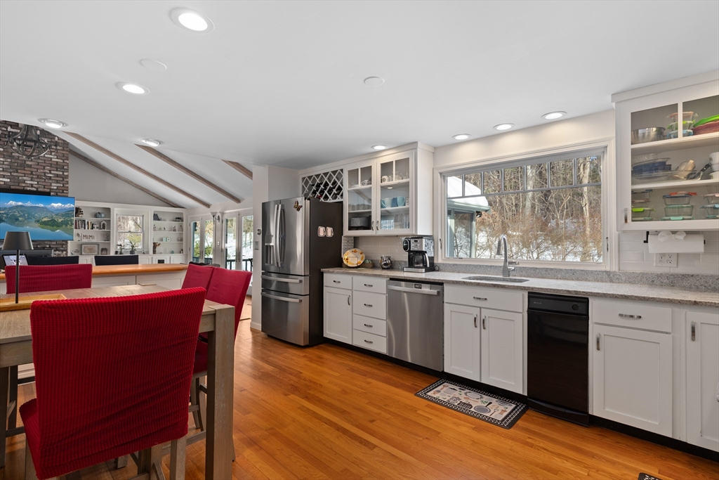 180 Rowley Bridge Road Topsfield, MA 01983 - Photo 6 of 42 a kitchen with stainless steel appliances granite countertop a kitchen island hardwood floor sink stove dining table and chairs