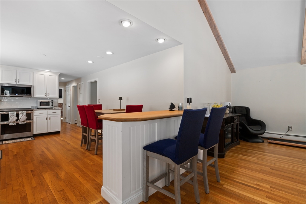 180 Rowley Bridge Road Topsfield, MA 01983 - Photo 8 of 42 a view of a dining room with furniture and wooden floor