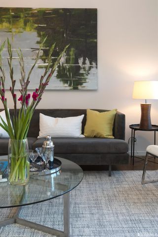 a living room with couch and a potted plant