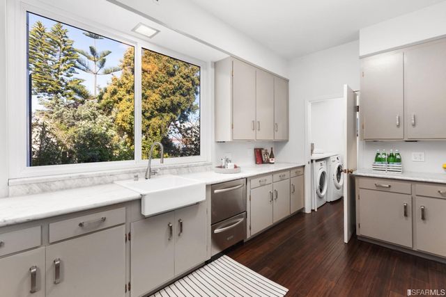 a kitchen with a sink window and cabinets